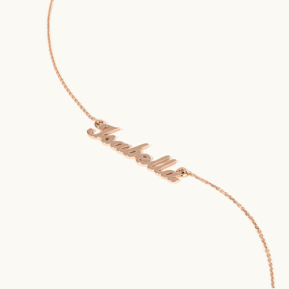 Angled view of Jewellers District's Personalizable Gold Name Necklace in 14k Rose Gold